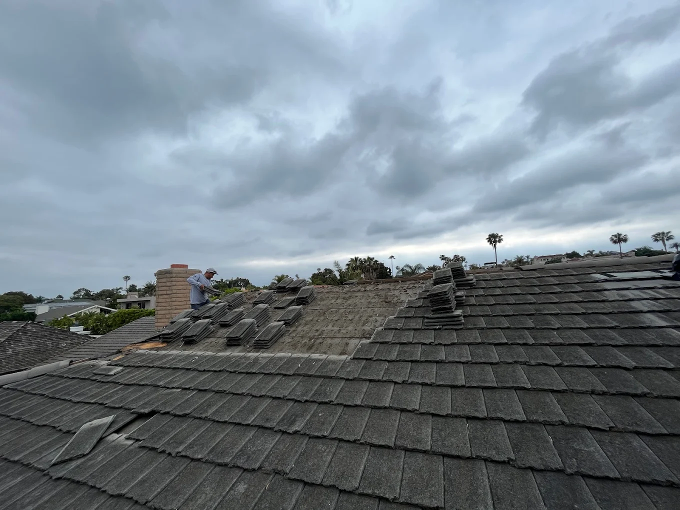 Mid-century home with new roof and crew finishing the work