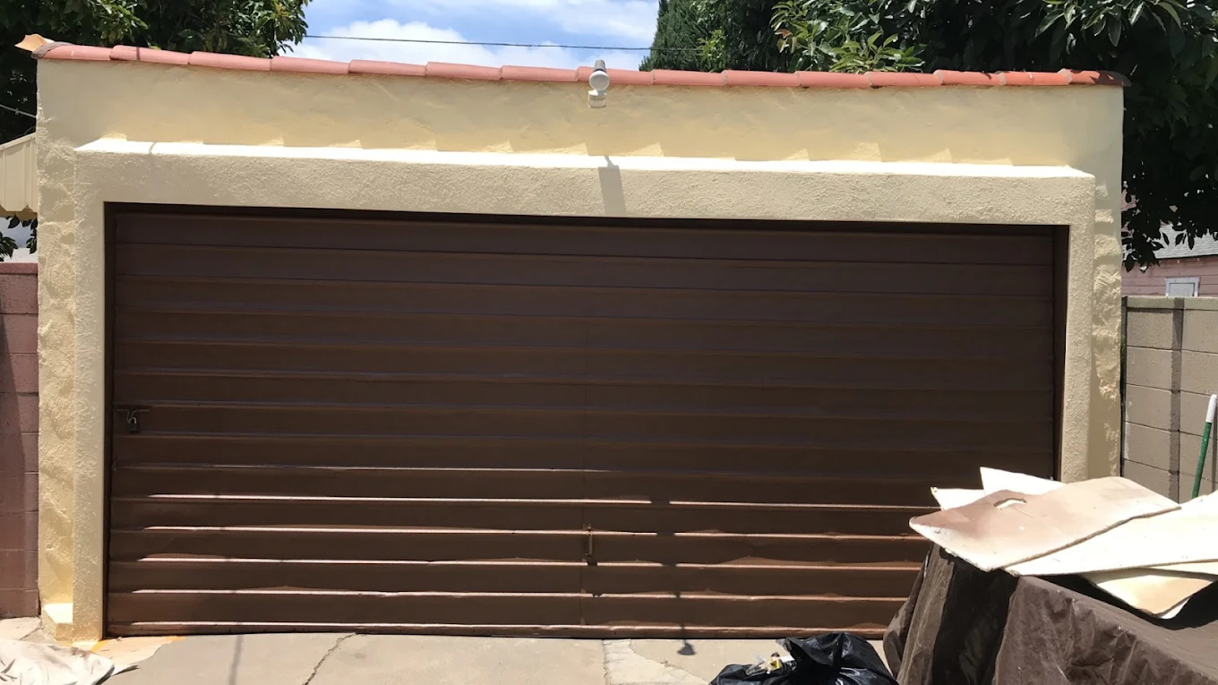 Garage and stucco wall painted in matching desert tones