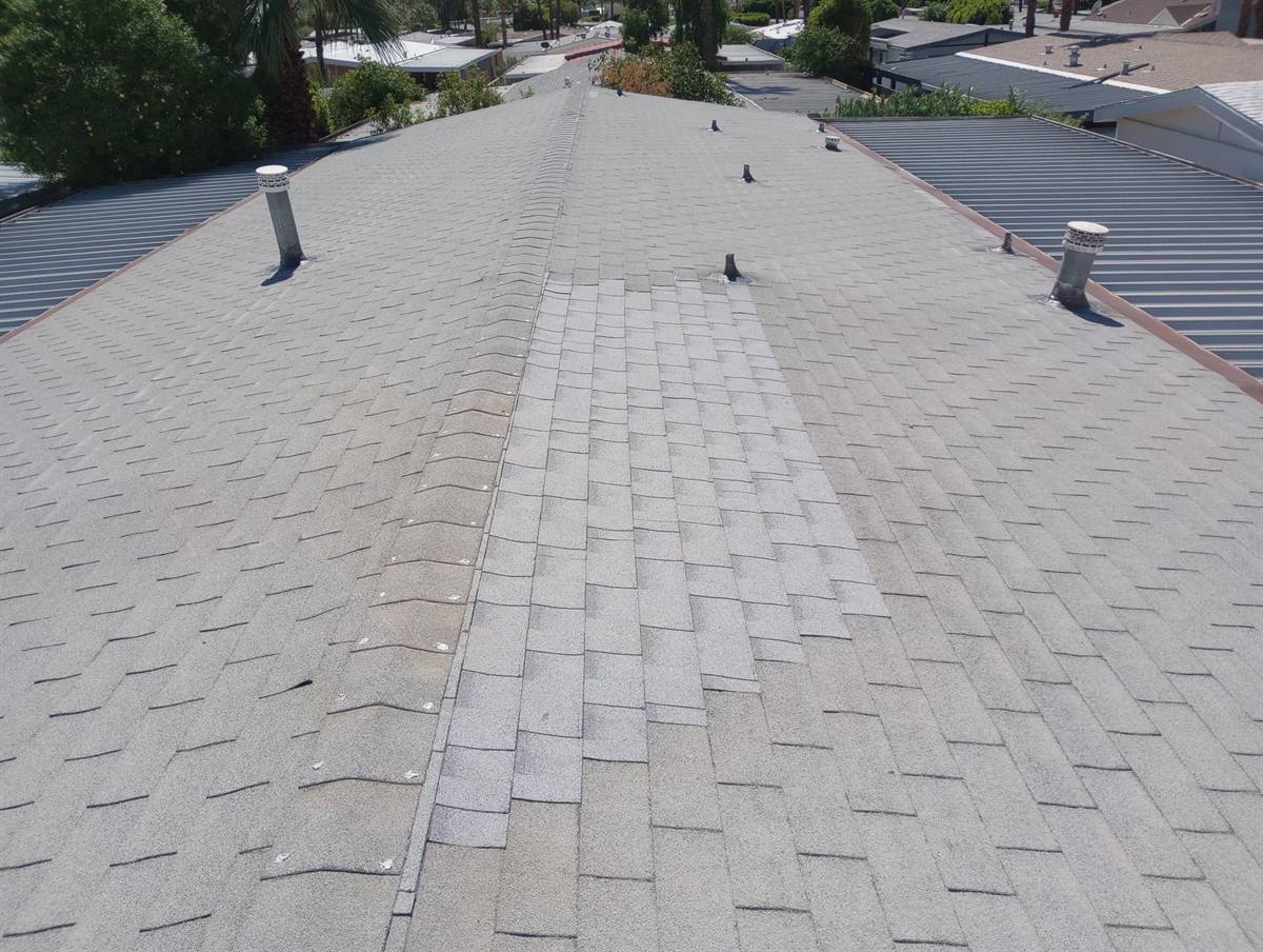 Finished asphalt shingle repair along a ridge