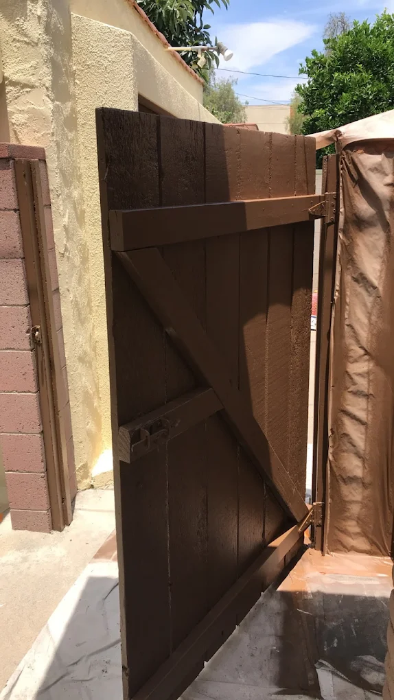 Wood gate restored and stained in rich brown