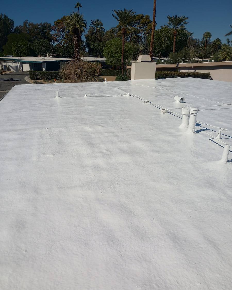 Coated vents and conduit across a finished foam roof
