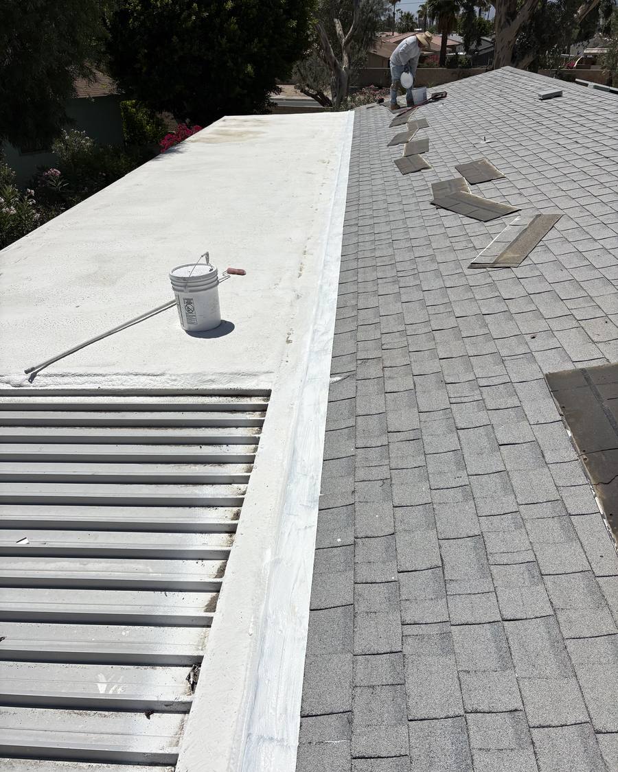 Coated low-slope section where it meets an asphalt shingle roof
